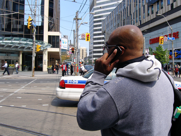 Talking on the Phone, Waiting to Cross Bay at Dundas