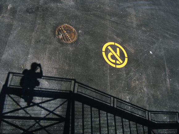 Sewer Grate and No Parking Above the Staircase